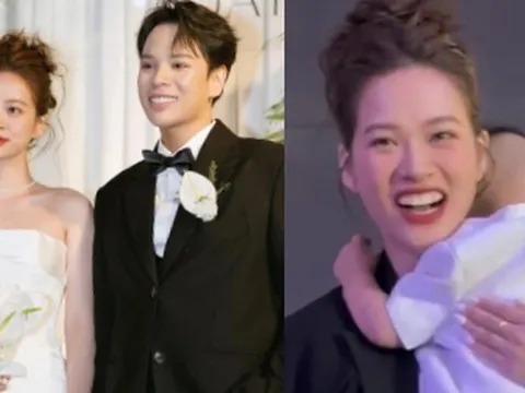 Đang diện váy cô dâu, vợ JayKii 'xả vai' bồng bế ru con ngủ giữa đám cưới